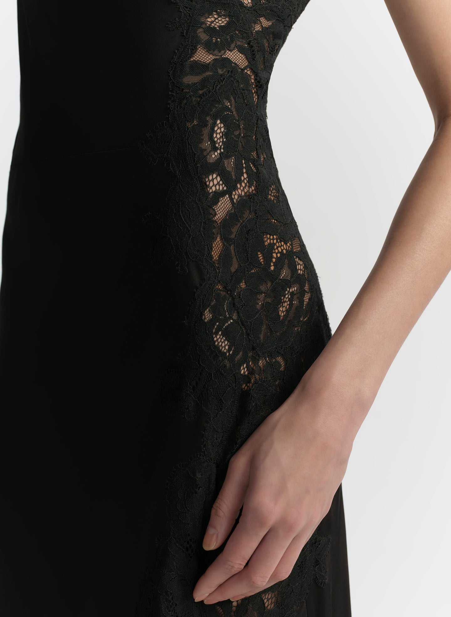 Woman wearing a black one-shoulder dress on a white background