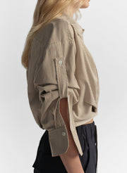 woman wearing brown striped shirt and navy blue pants