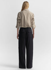 woman wearing brown striped shirt and navy blue pants