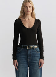 woman wearing black long sleeve tee shirt and denim jeans