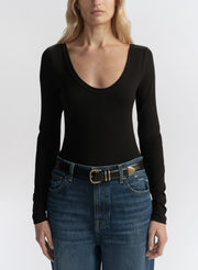 woman wearing black long sleeve tee shirt and denim jeans