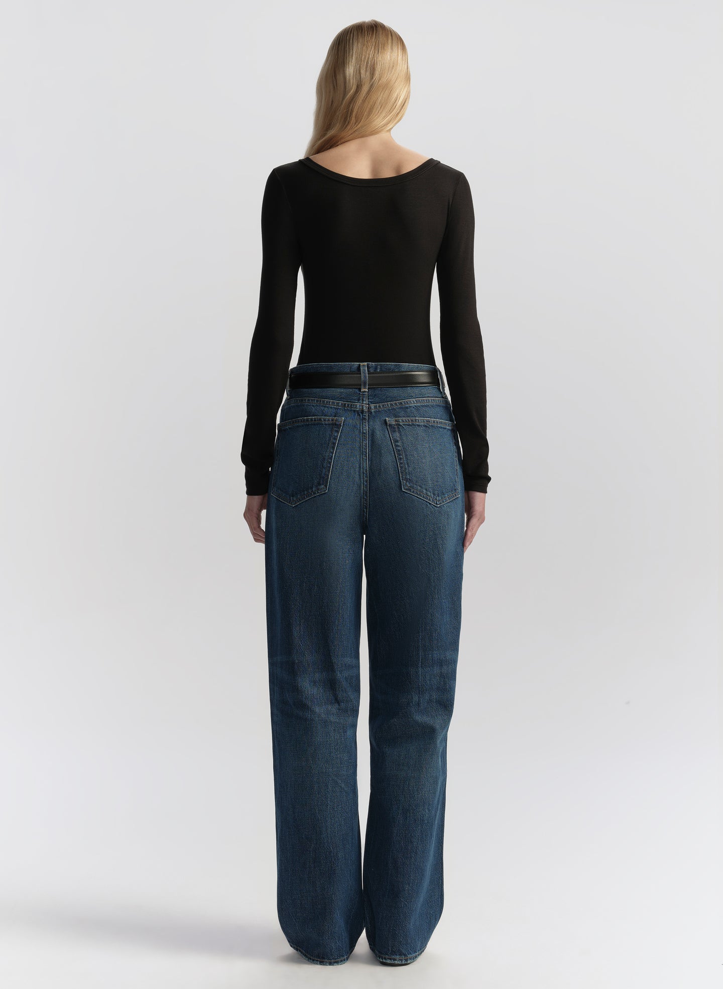 woman wearing black long sleeve tee shirt and denim jeans