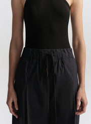 woman wearing black tank top and dark blue pants