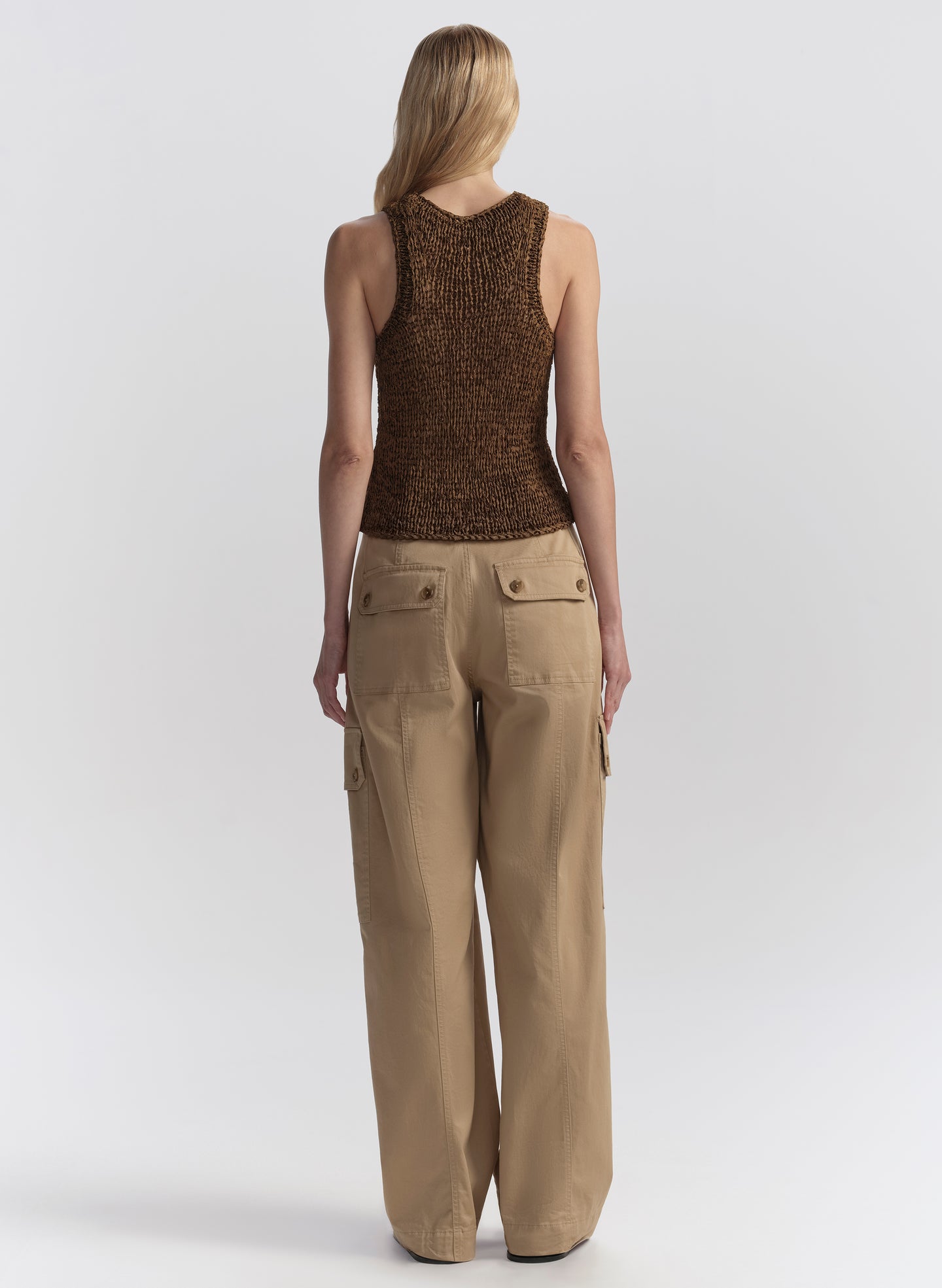 woman wearing brown tank top and tan cargo pants