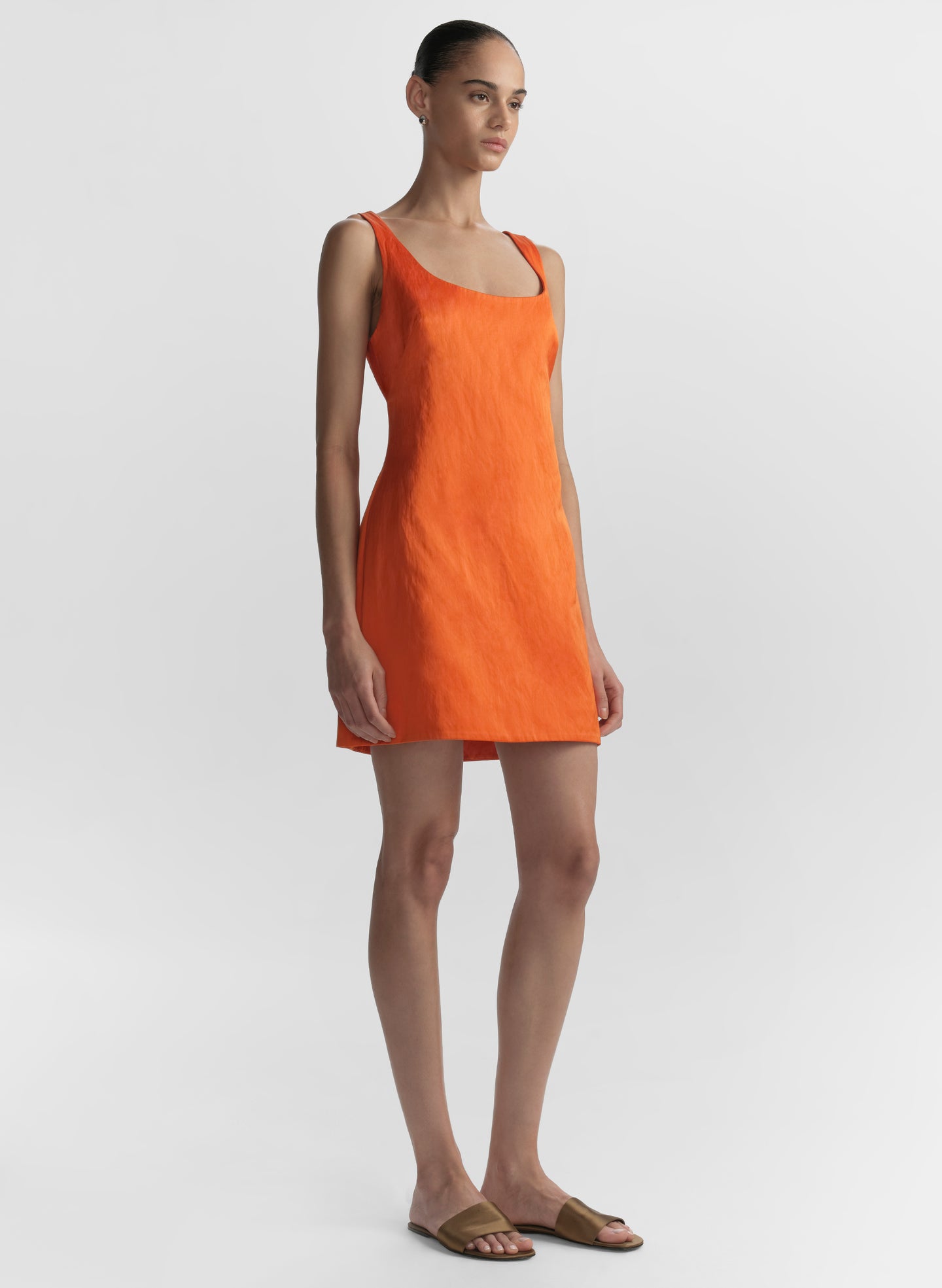 woman wearing orange mini dress