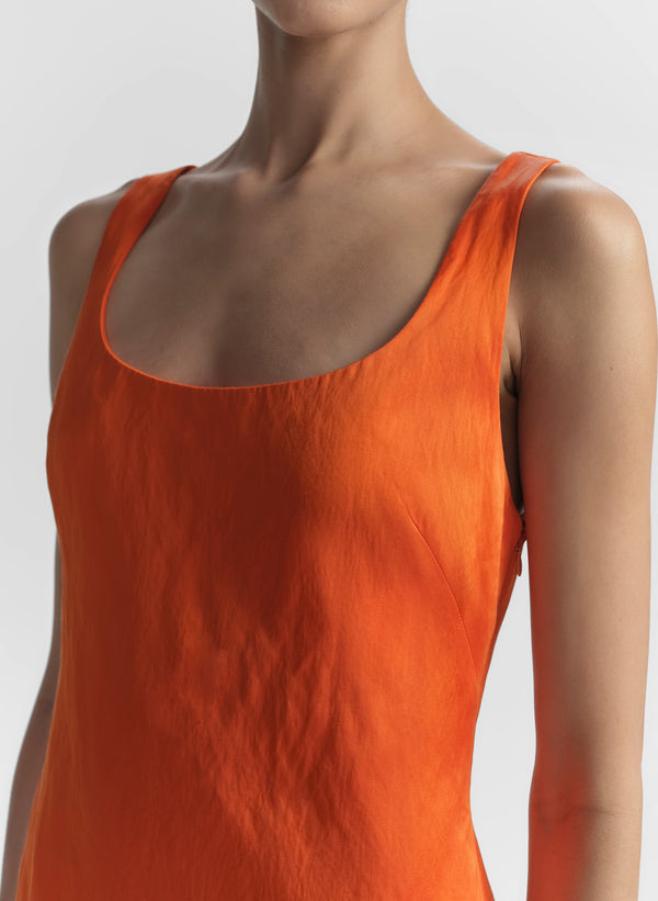 woman wearing orange mini dress