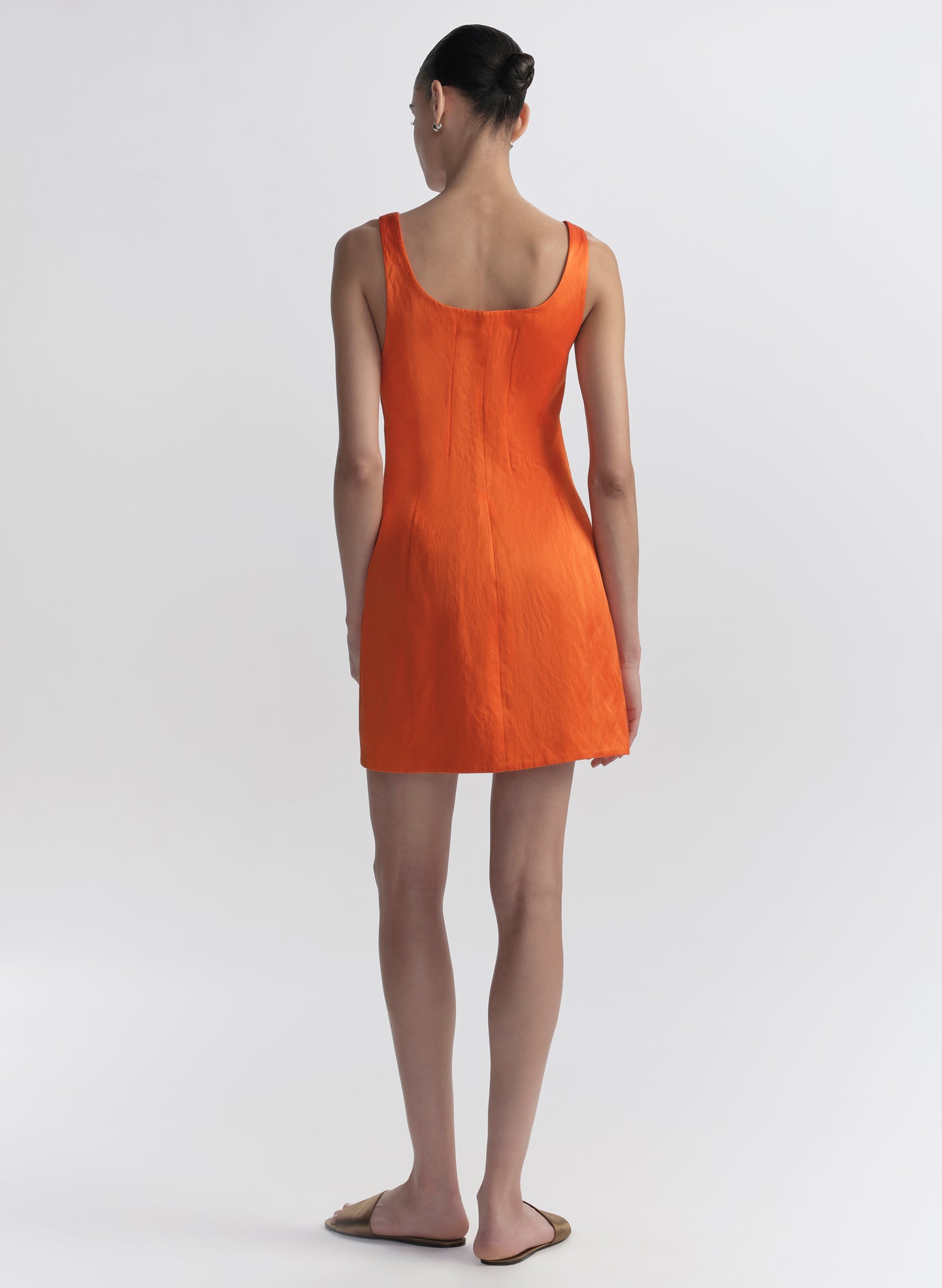 woman wearing orange mini dress
