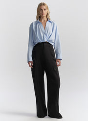 woman wearing light blue shirt and navy blue cargo pants