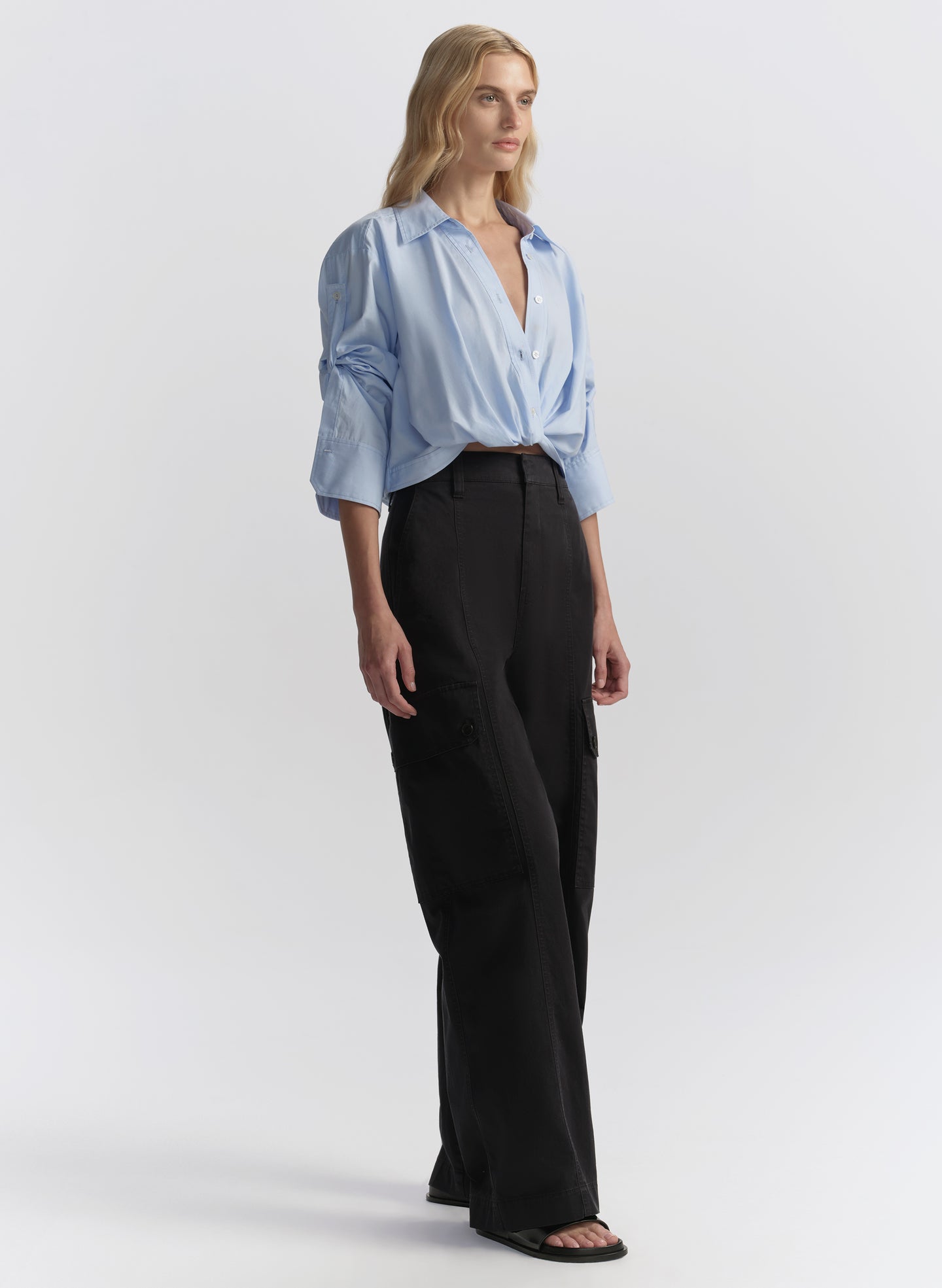 woman wearing light blue shirt and navy blue cargo pants