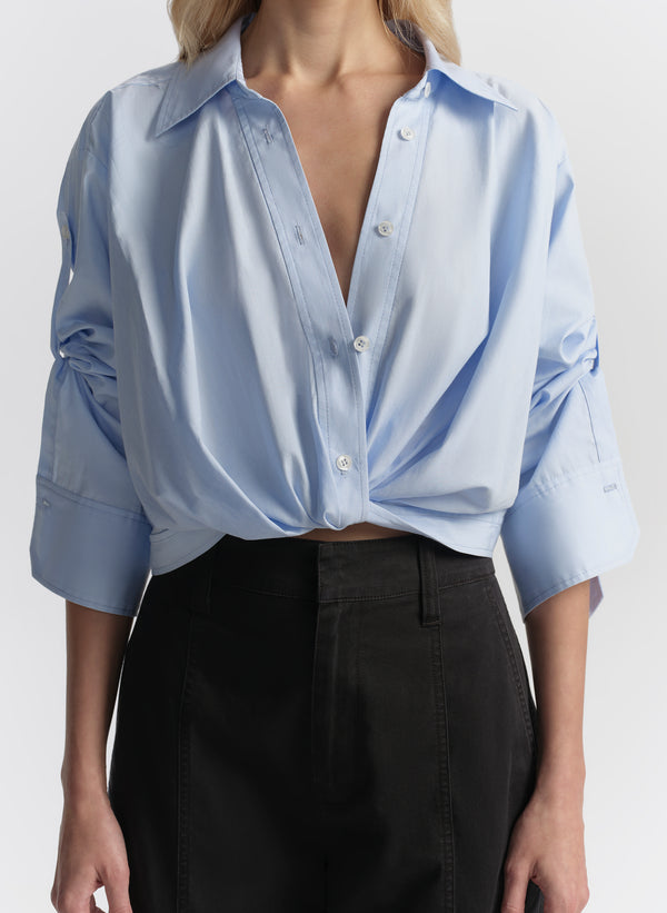 woman wearing light blue shirt and navy blue cargo pants