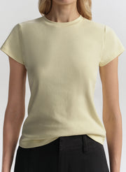 Person wearing a light yellow t-shirt against a plain background