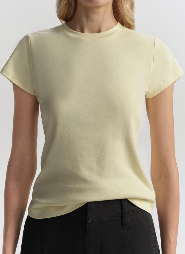 Person wearing a light yellow t-shirt against a plain background
