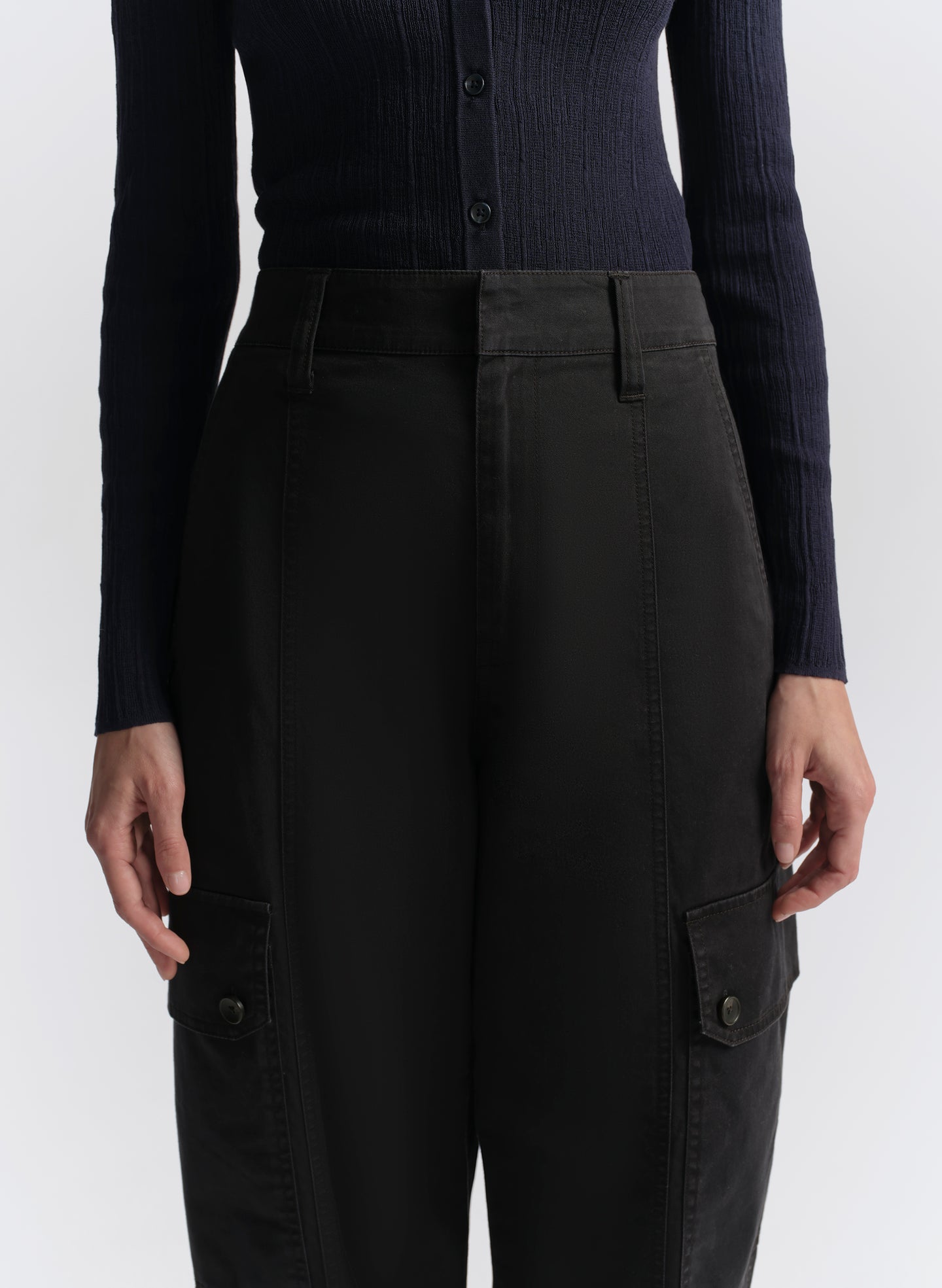 woman wearing navy blue cardigan and navy blue cargo pants
