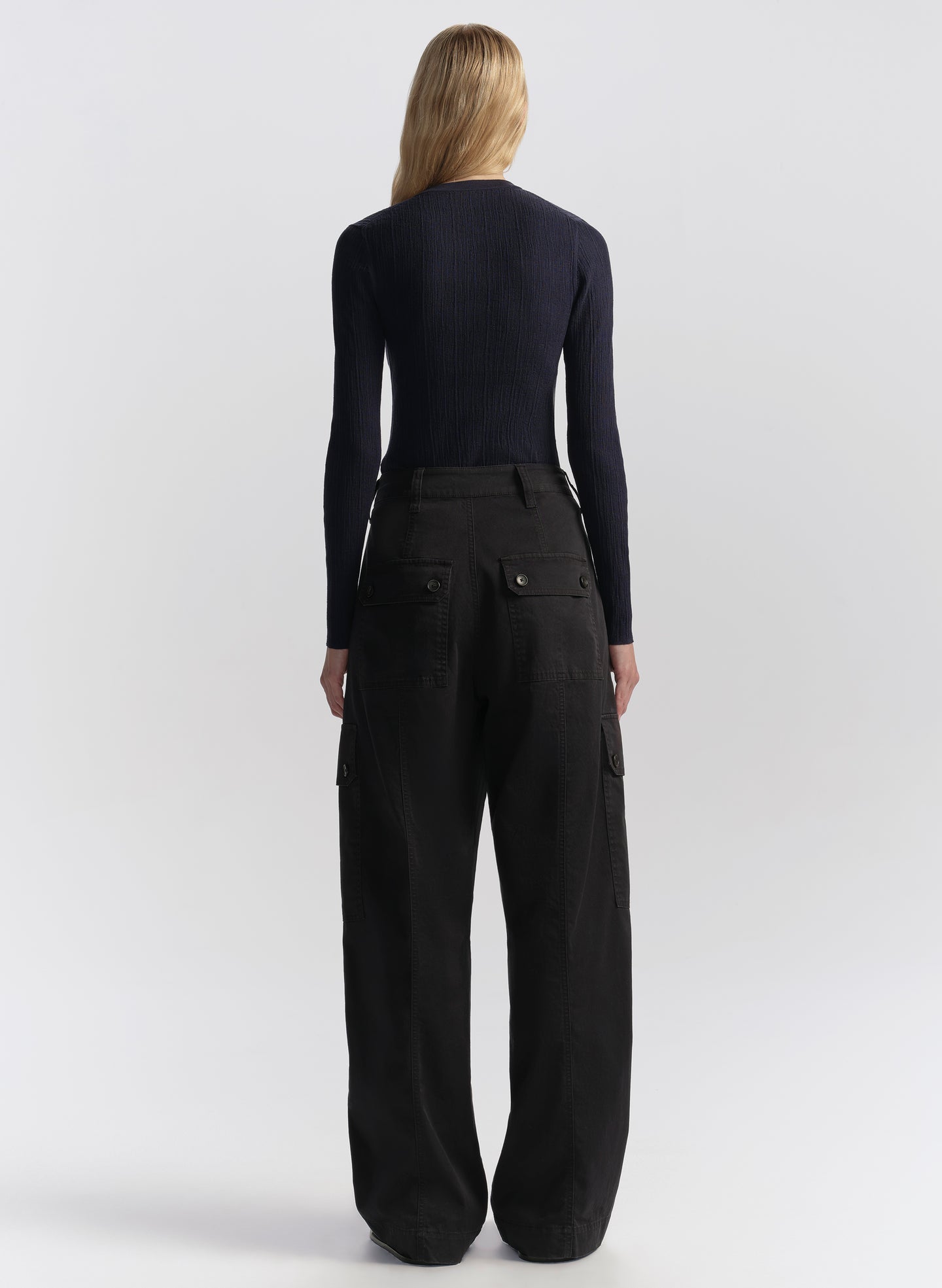 woman wearing navy blue cardigan and navy blue cargo pants