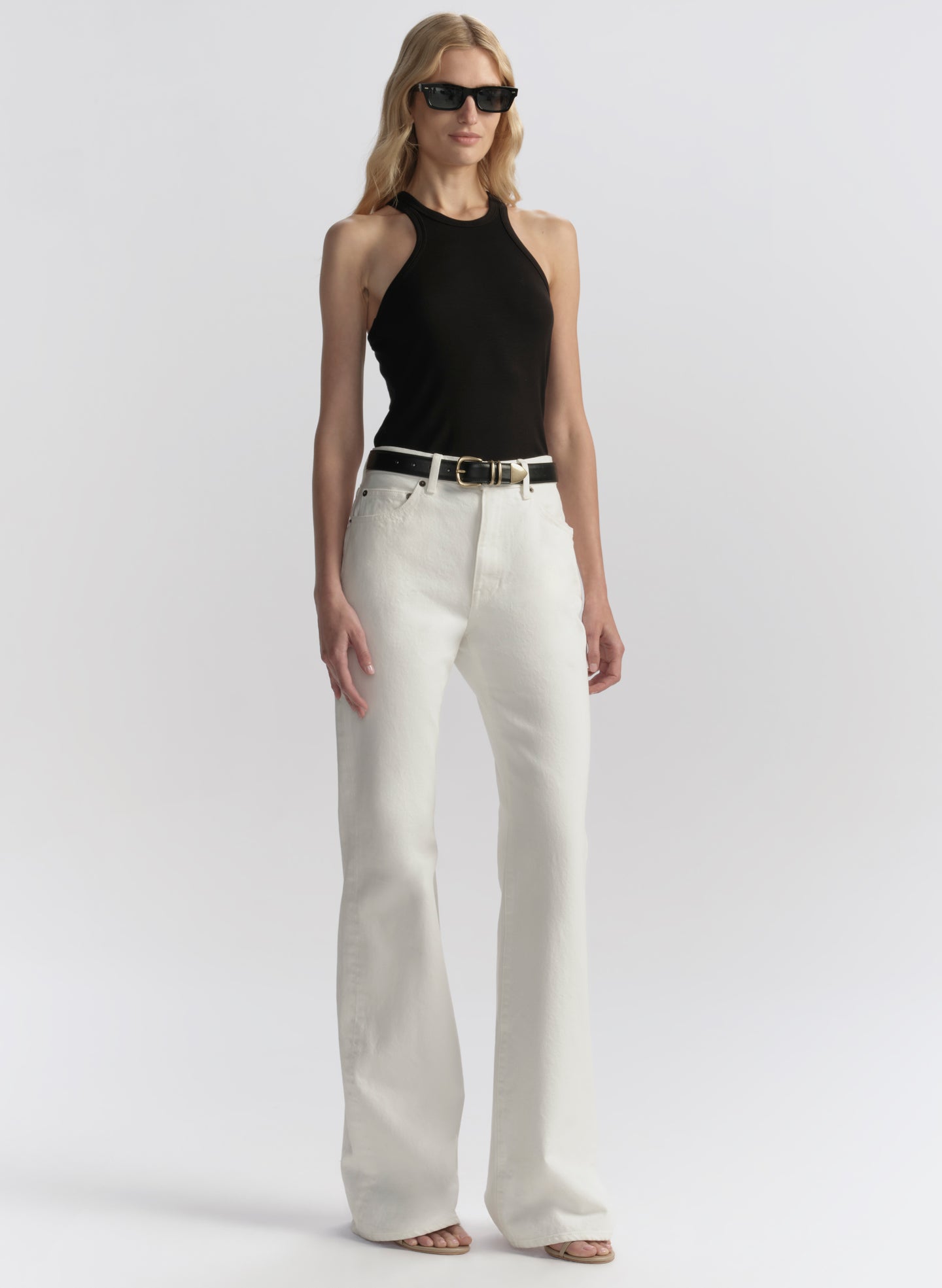 woman wearing black tank top and white denim jeans