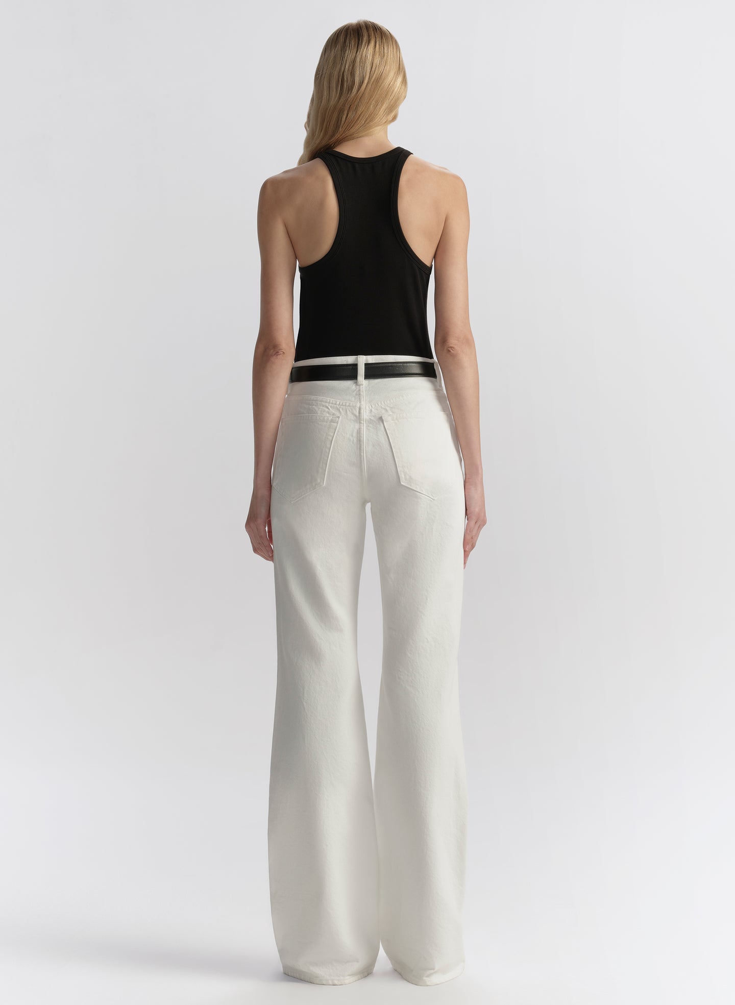 woman wearing black tank top and white denim jeans