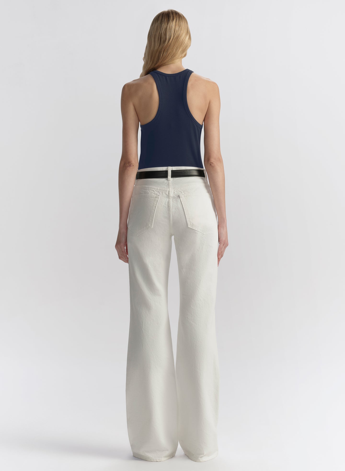 woman wearing blue tank top and white denim jeans