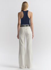 woman wearing blue tank top and white denim jeans