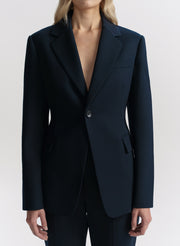 Blue blazer worn by a person on a white background
