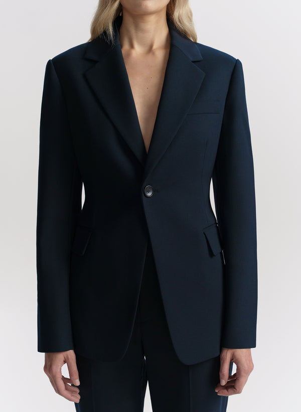 Blue blazer worn by a person on a white background