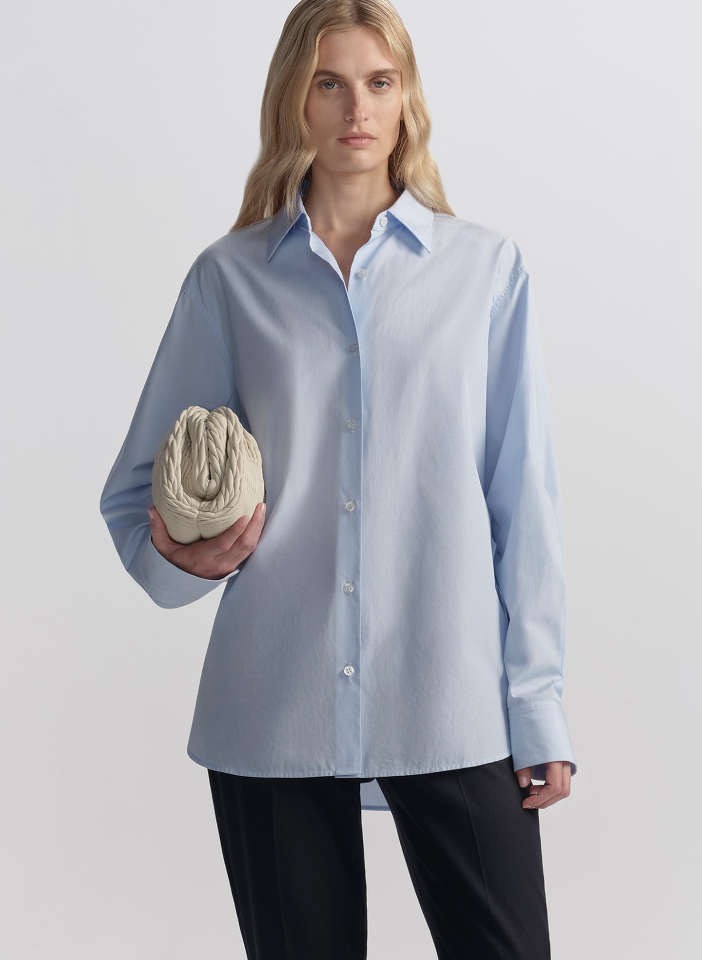 woman wearing light blue shirt and black pants