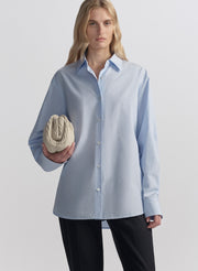 woman wearing light blue shirt and black pants