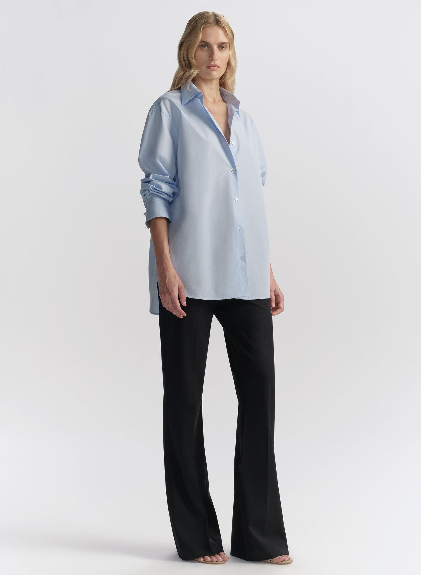 woman wearing light blue shirt and black pants