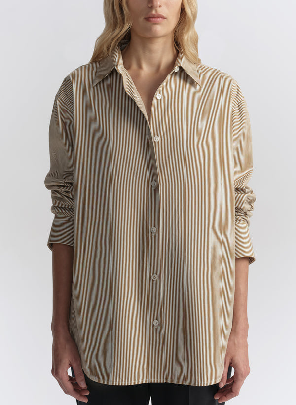 woman wearing brown striped shirt and black pants