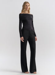 woman wearing dark blue off shoulder tee