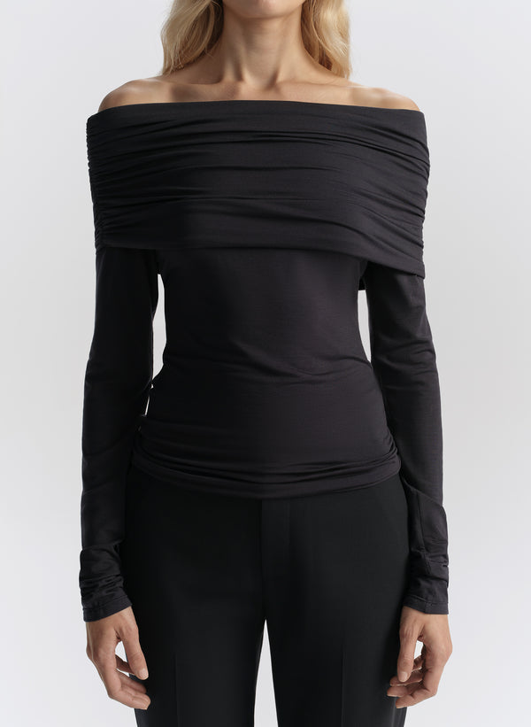 woman wearing dark blue off shoulder tee