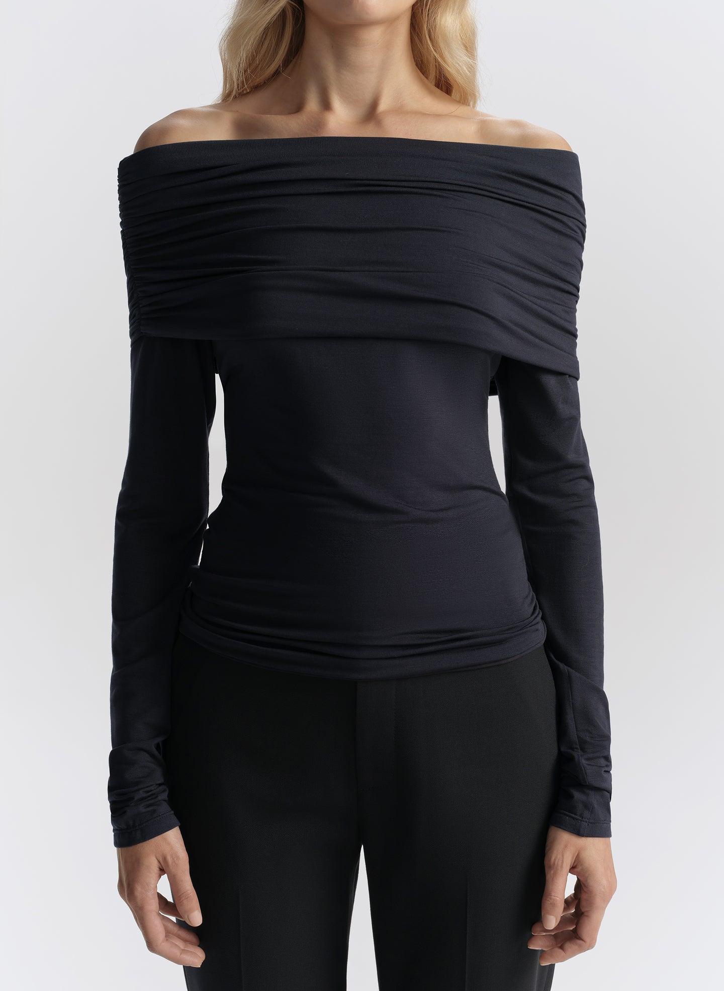 woman wearing navy off shoulder tee