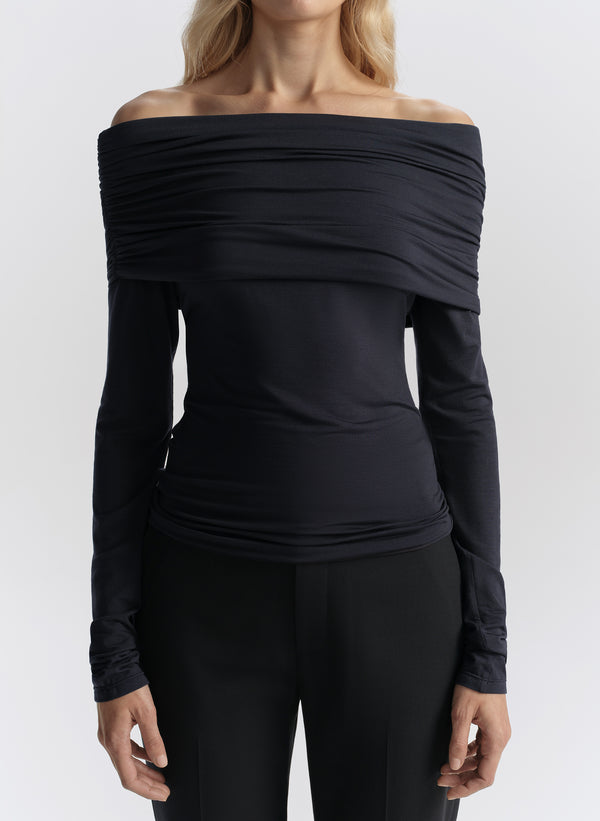 woman wearing navy off shoulder tee