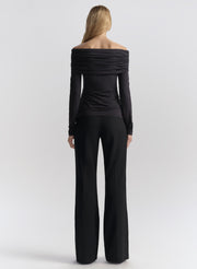 woman wearing dark blue off shoulder tee