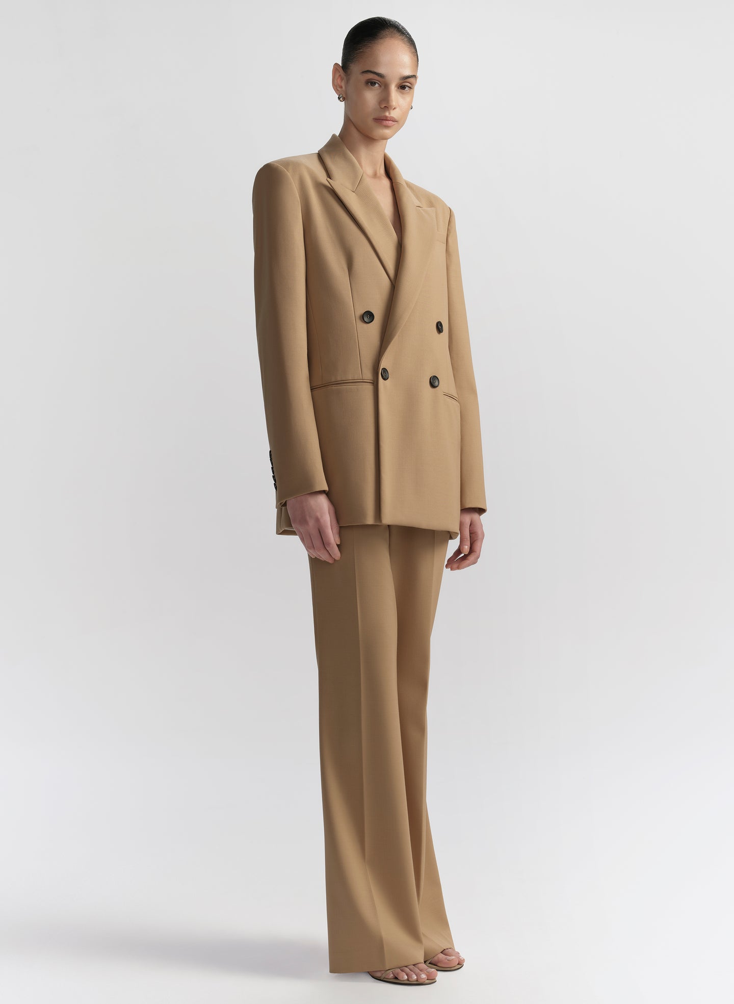 woman wearing tan suit