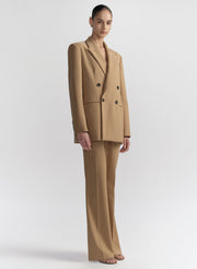 woman wearing tan suit