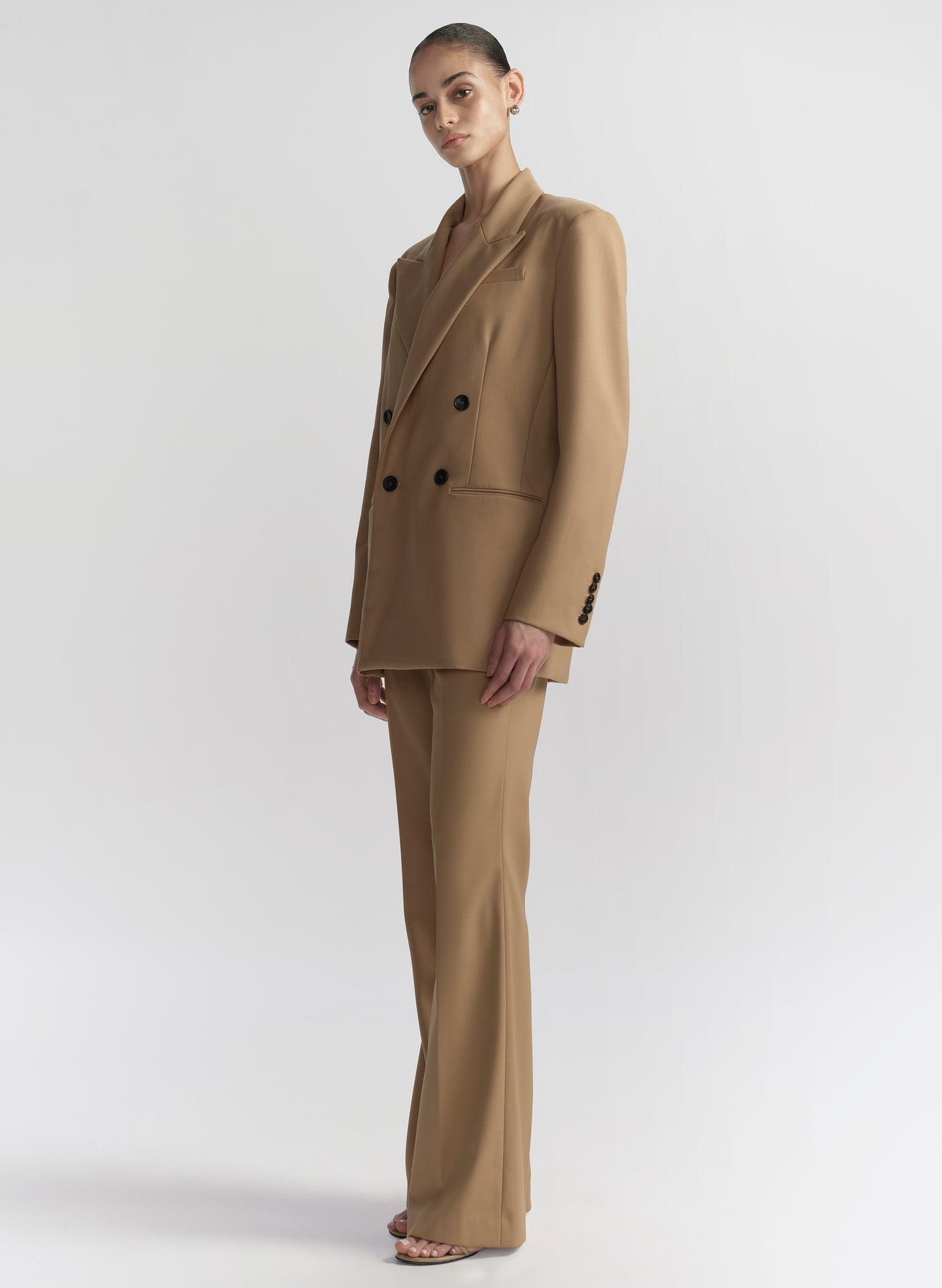 woman wearing tan suit