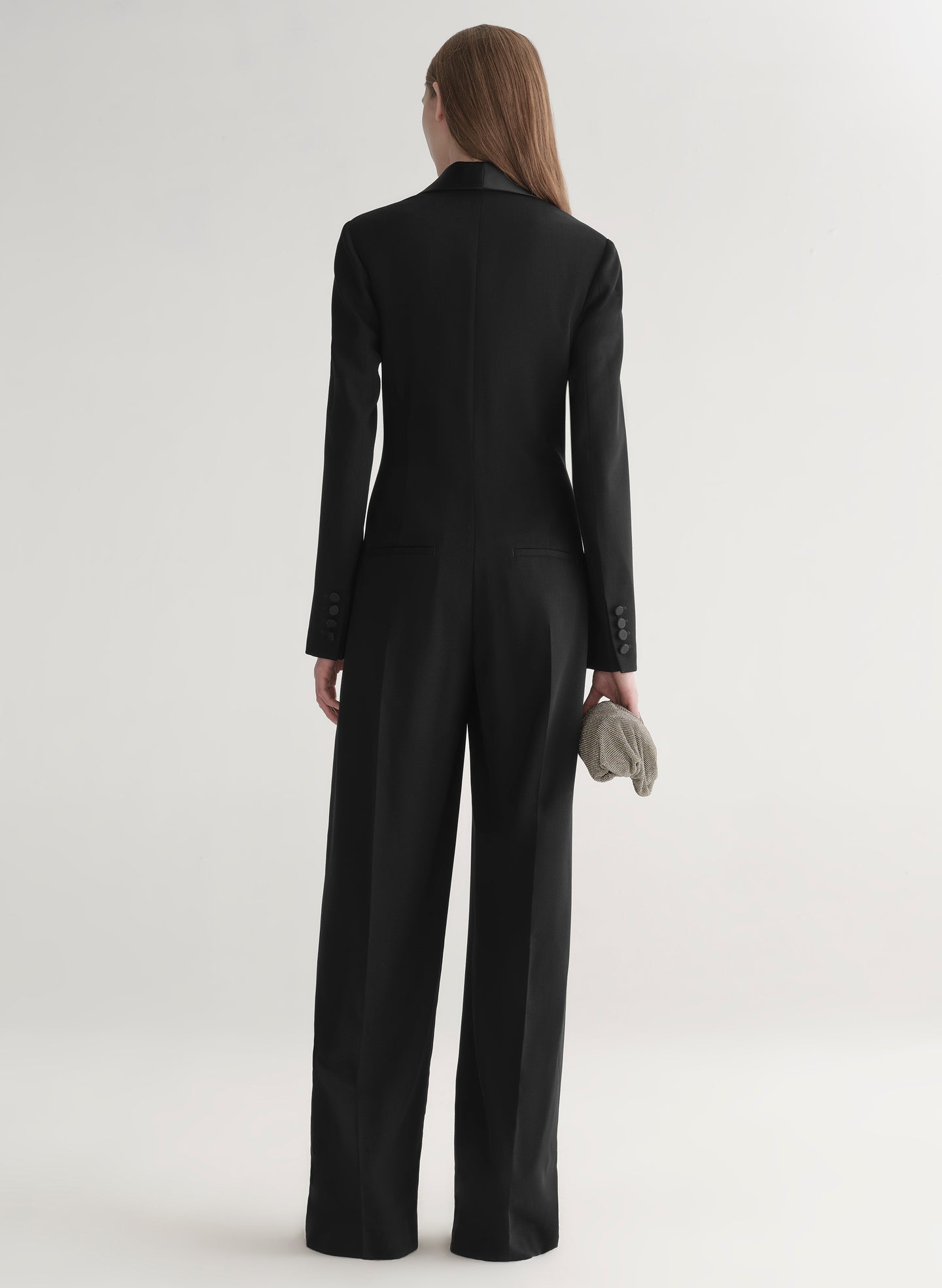 Person wearing a black jumpsuit on a white background