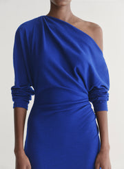Blue one-shoulder dress on a plain background