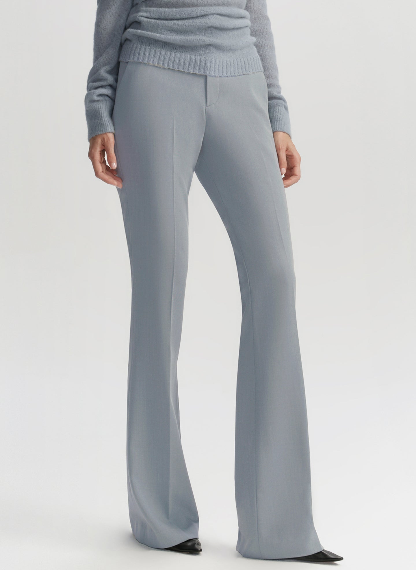 Light gray wide-leg pants worn with a matching sweater on a white background