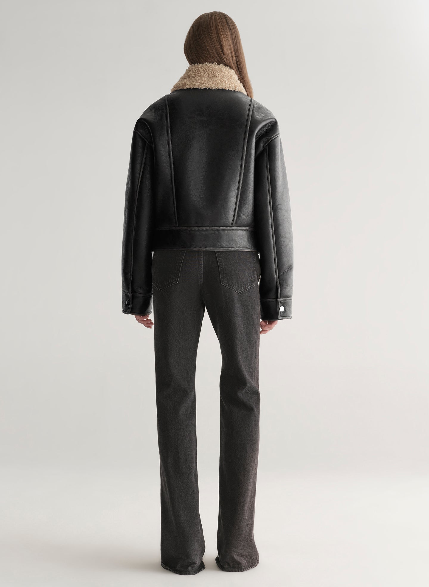 woman wearing faux leather and shearling jacket