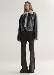 woman wearing faux leather and shearling jacket