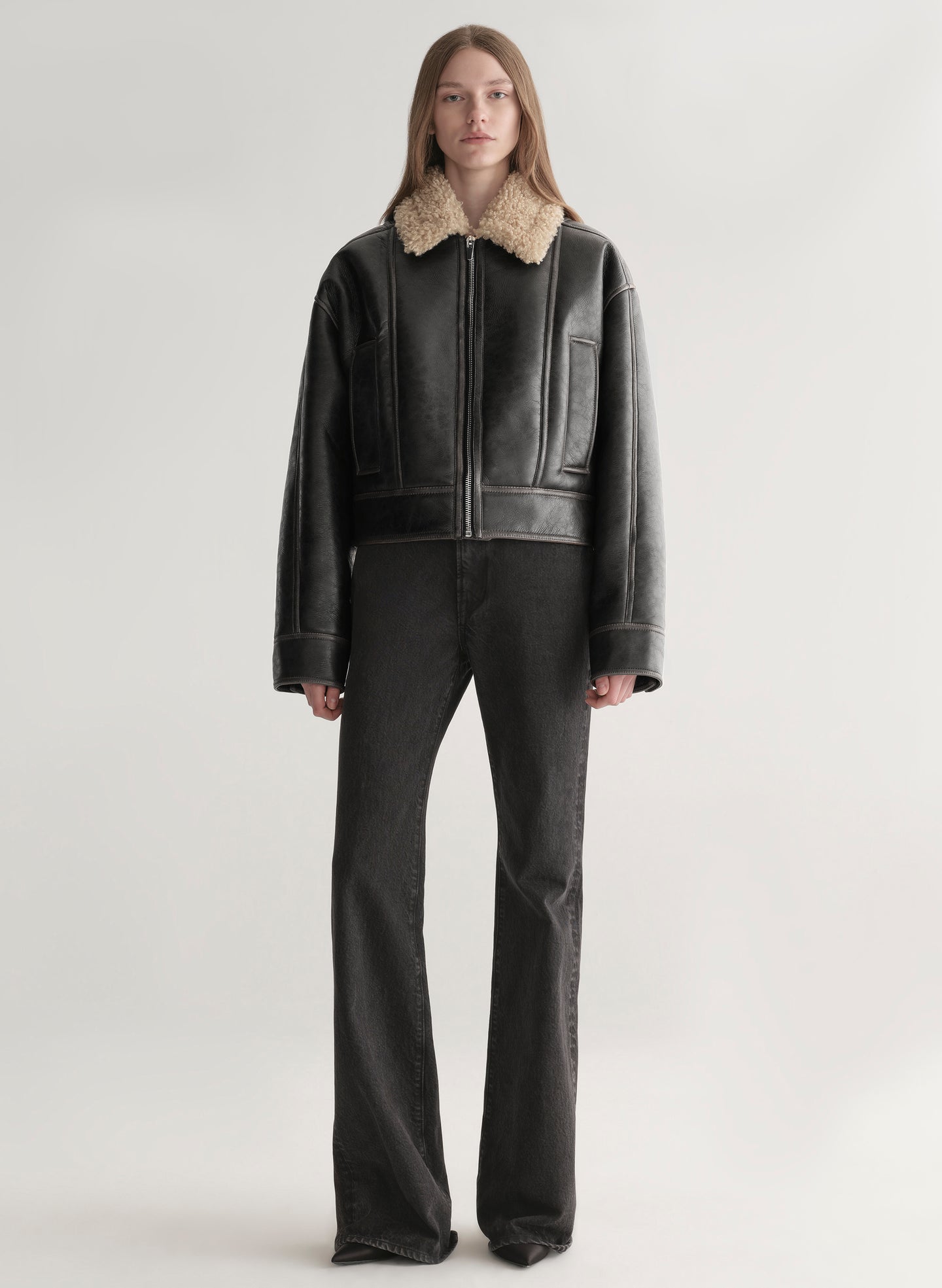 woman wearing faux leather and shearling jacket