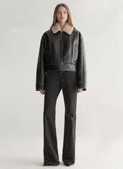 woman wearing faux leather and shearling jacket