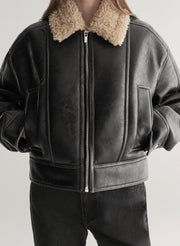 woman wearing faux leather and shearling jacket