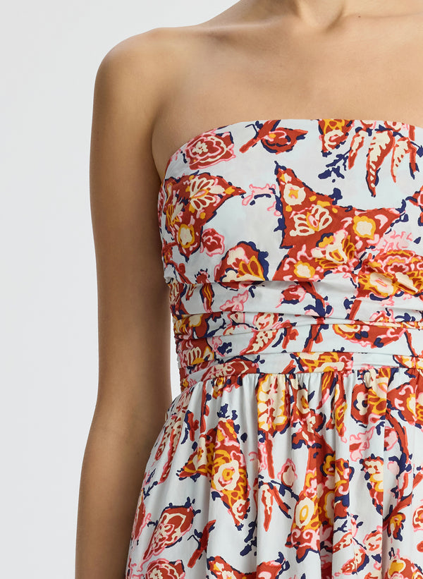 detail view of woman wearing multicolor printed strapless midi dress