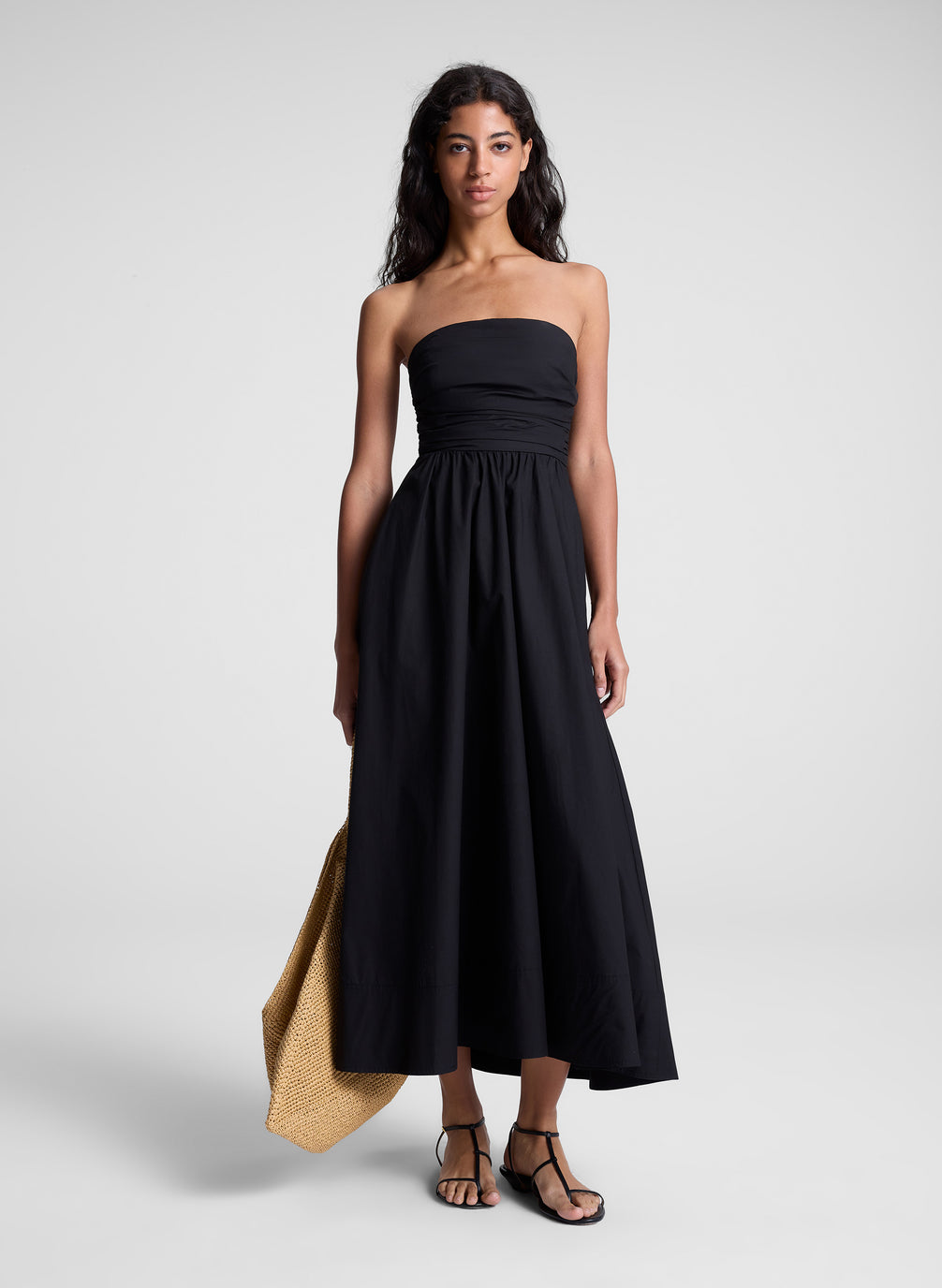 woman in black strapless midi dress