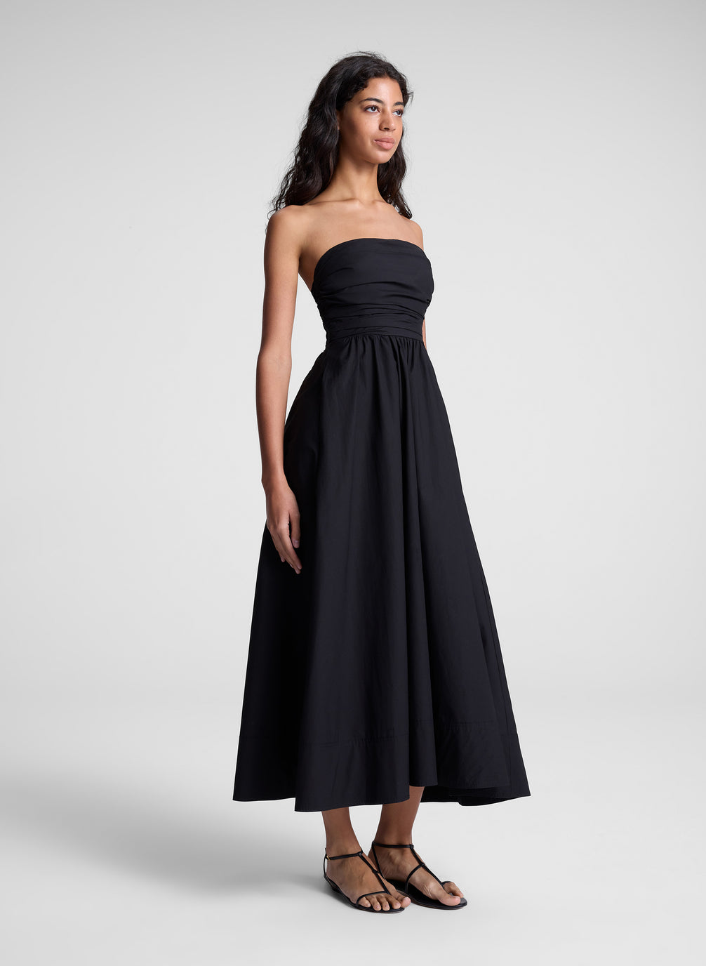 woman in black strapless midi dress