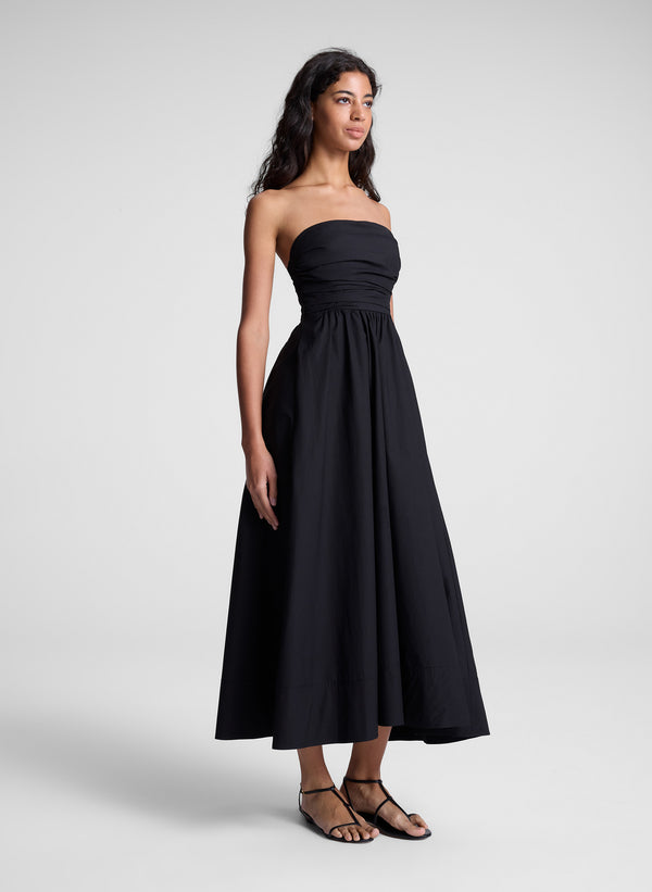 woman in black strapless midi dress