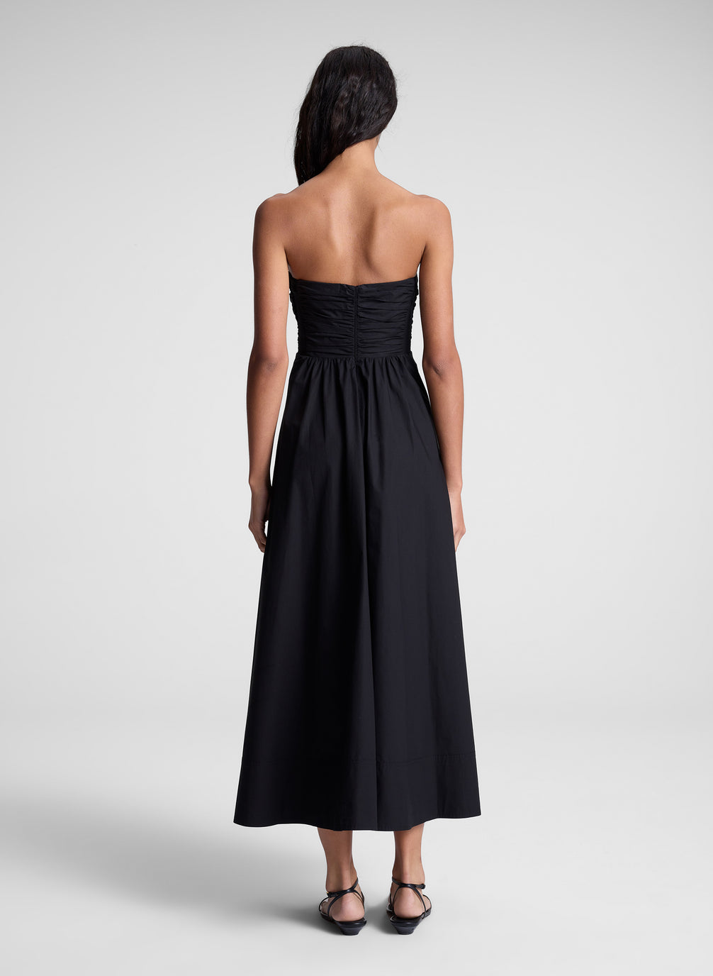 woman in black strapless midi dress