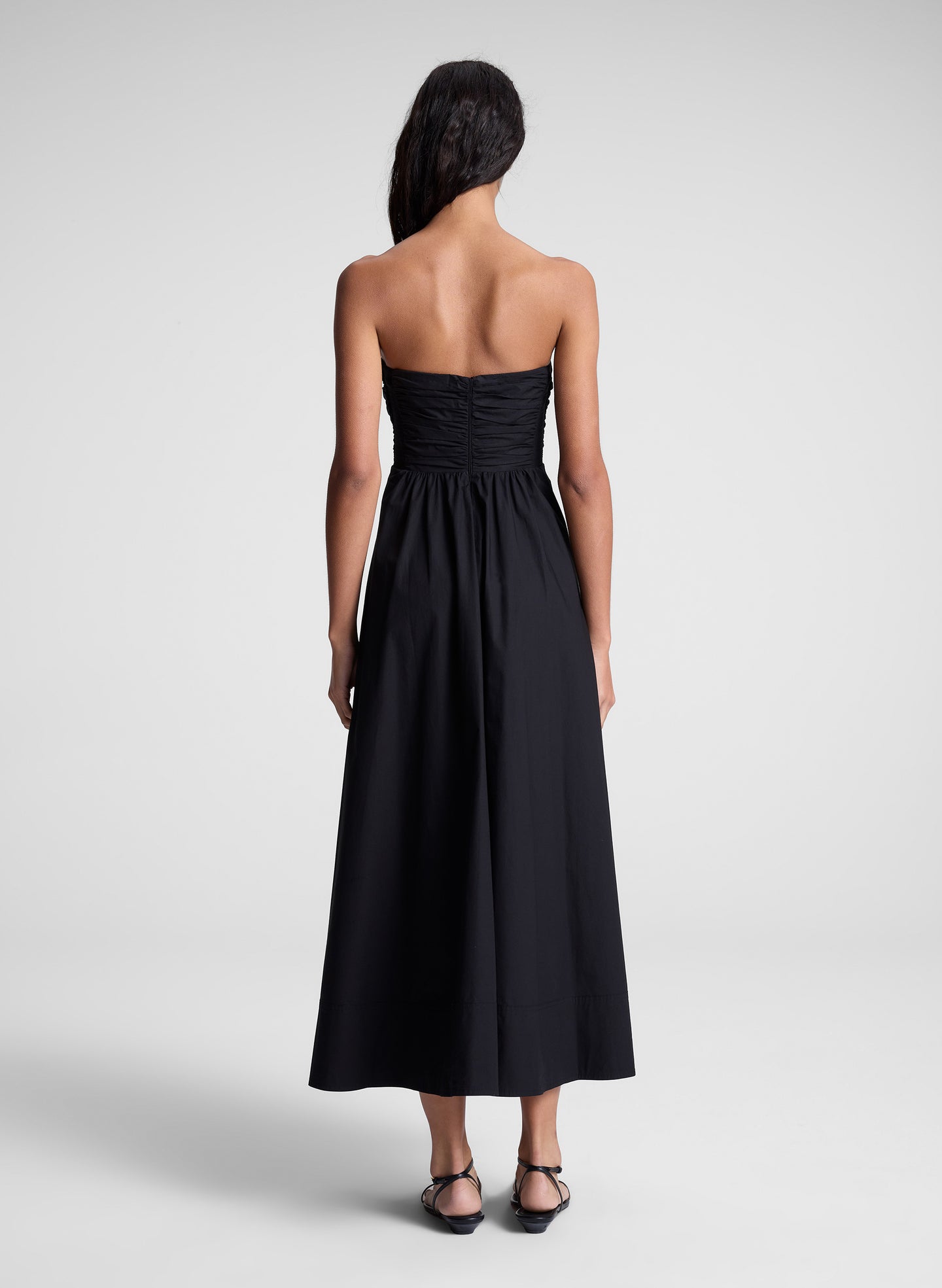 woman in black strapless midi dress